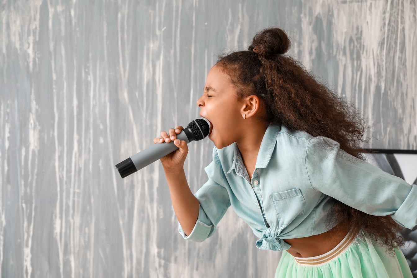 Little African-American Singer against Grunge Wall
