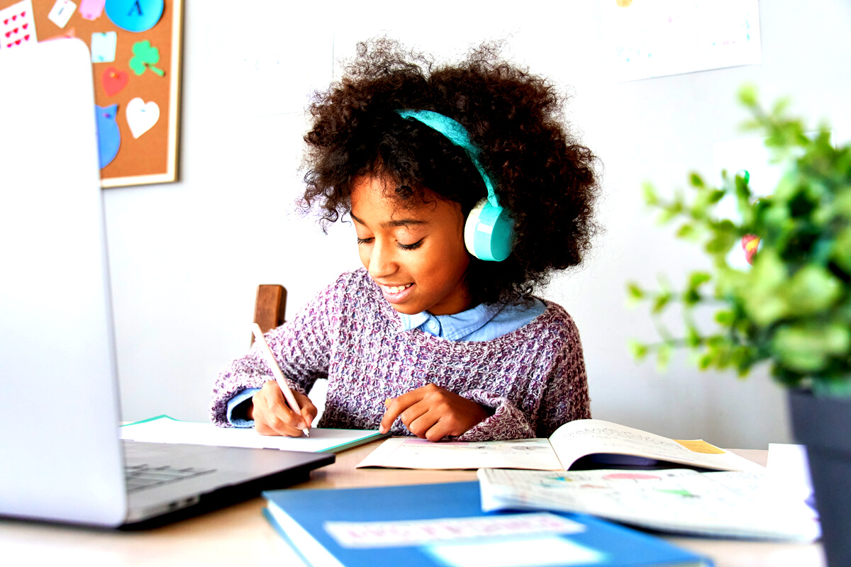 African School Kid Girl Wearing Headphones Virtual Distance Learning at Home.