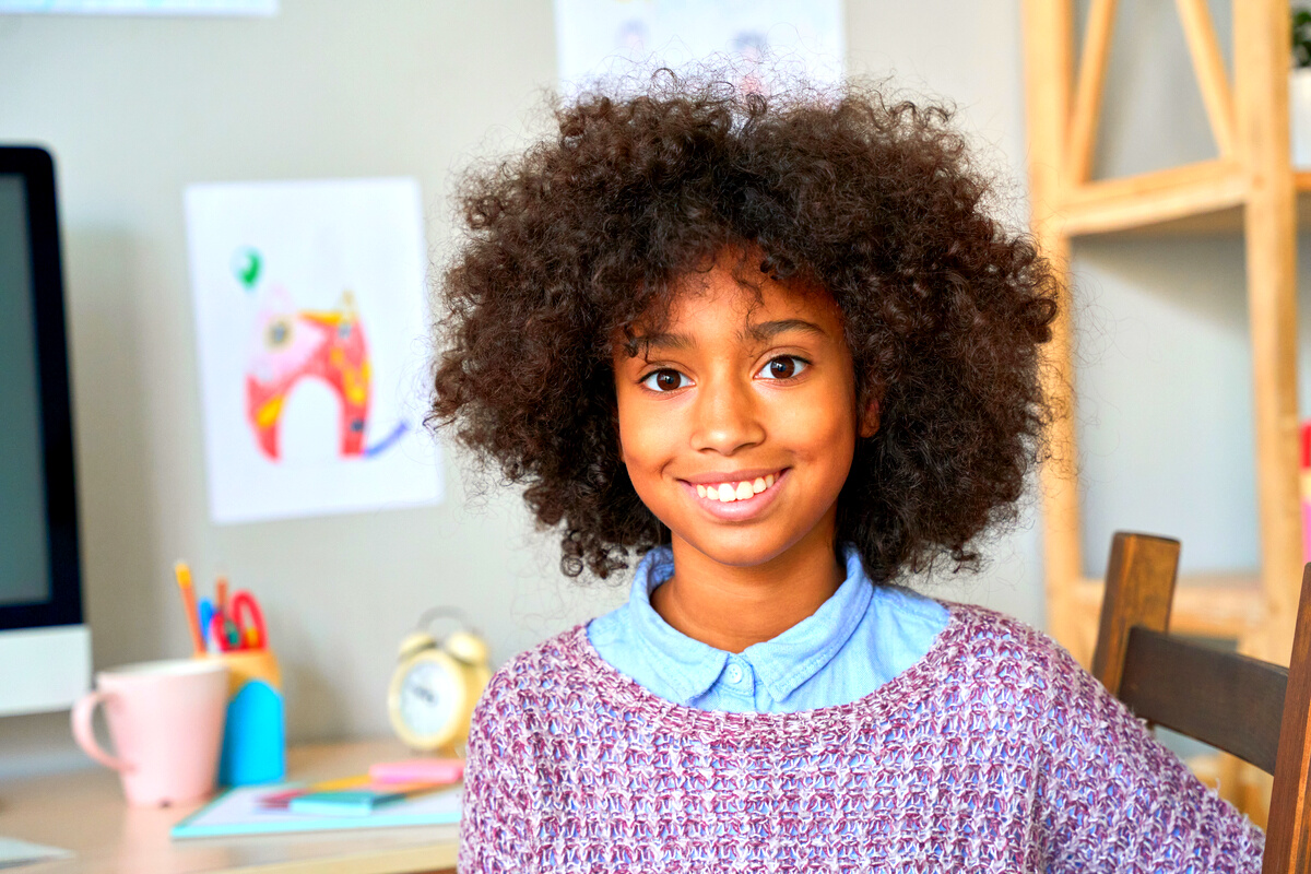 Headshot Portrait of Mixed Race Black African American Kid Model Indoors.