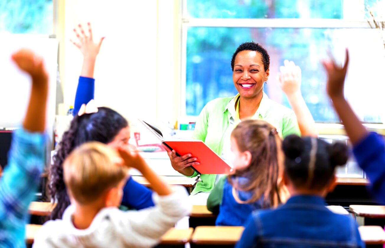 African-American teacher reading to school children