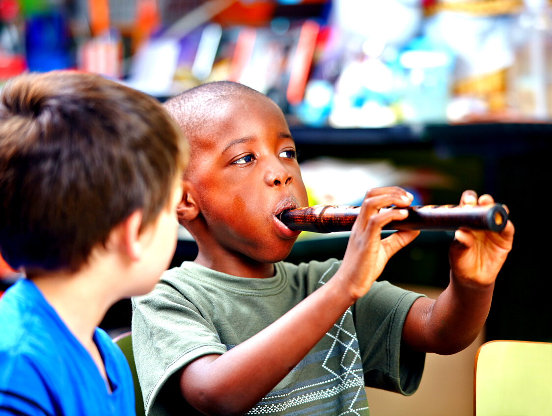 Child Playing Flute in Music School