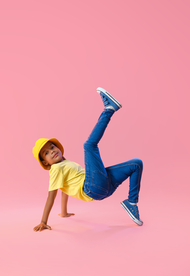 Dancing African-American Boy on Color Background