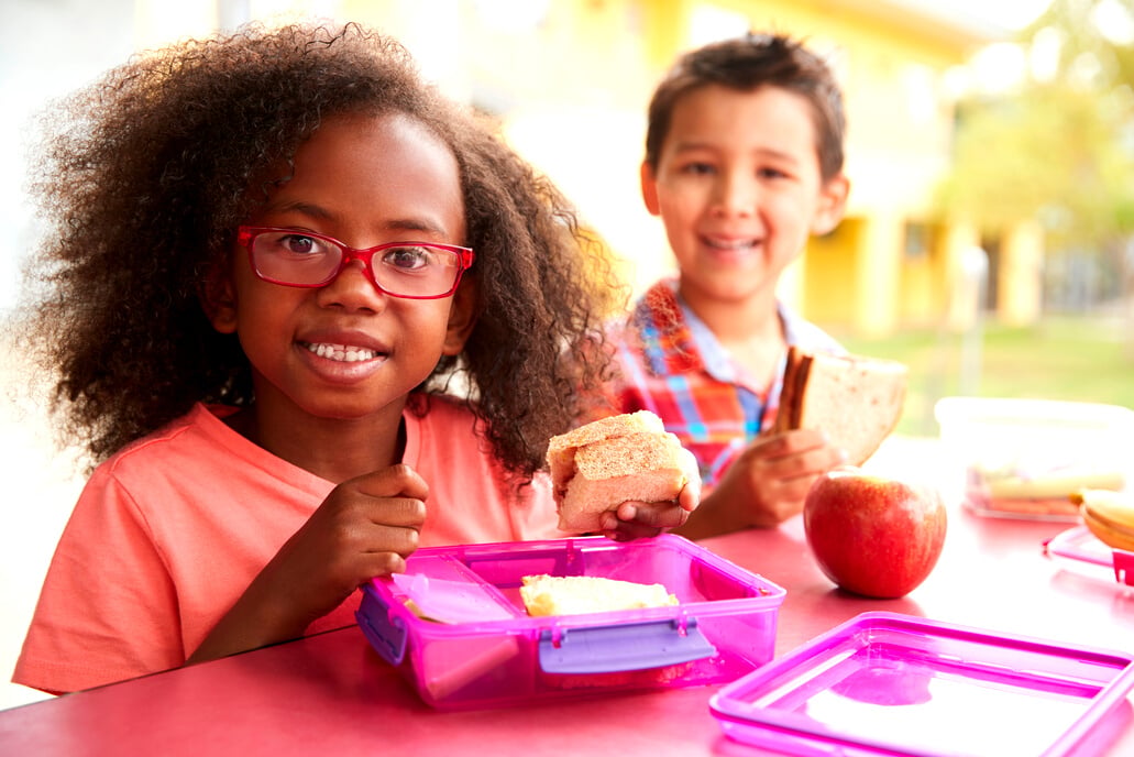 Two Young School Kids Eating Lunch