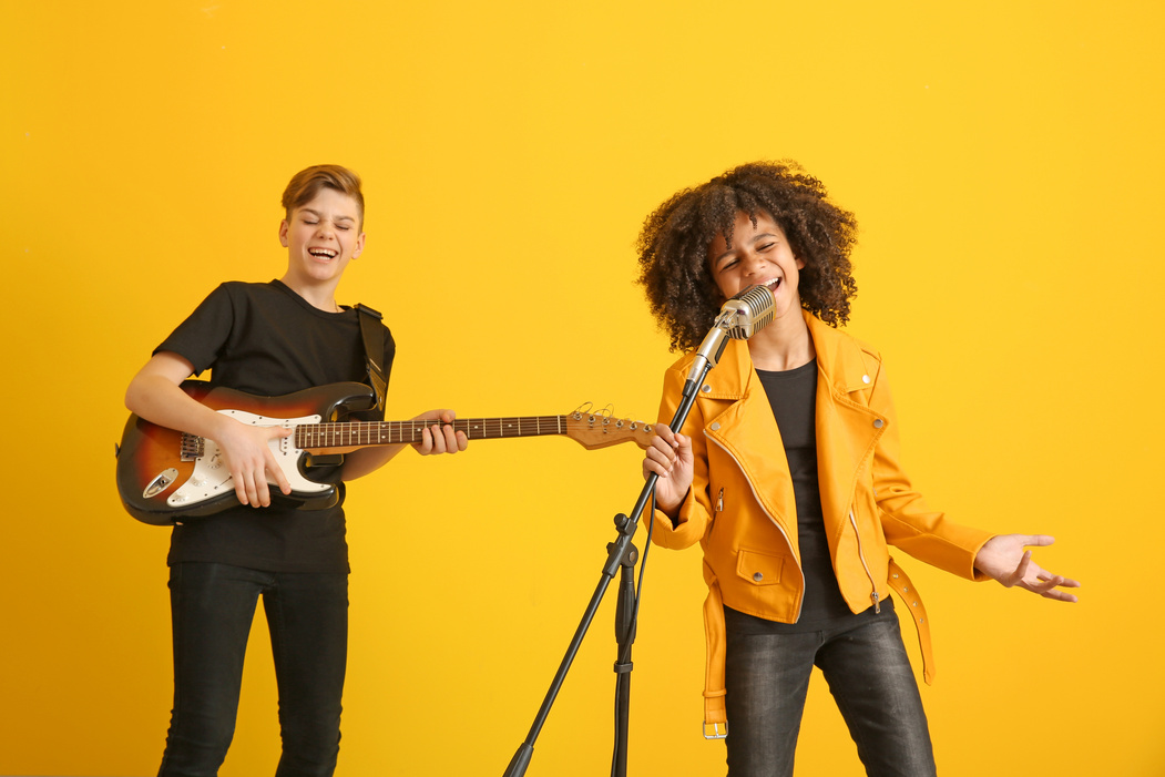 Teenage Musicians Playing against Color Background
